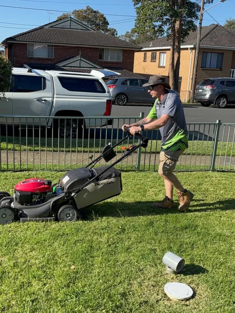 Wayne mowing a front lawn in Western Sydney